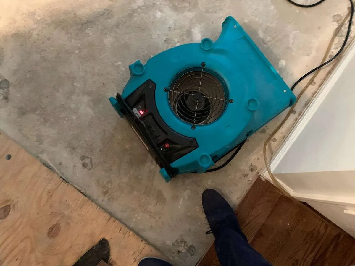 Air mover drying subfloor during Commercial Water Damage Restoration in Bel Aire